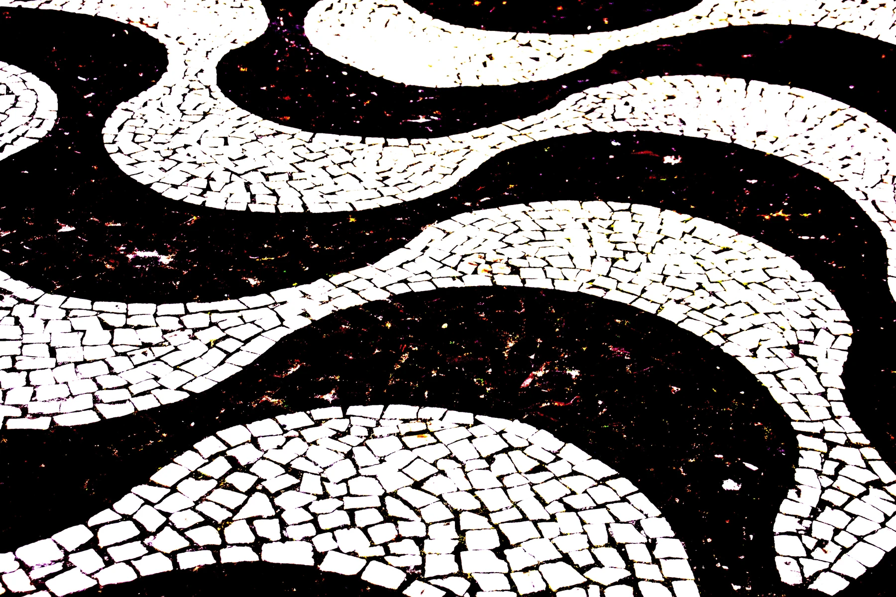 Padrão de ondas em um calçadão de pedras pretas e brancas